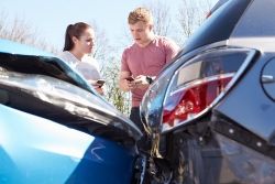 Two people exchanging information after an accident